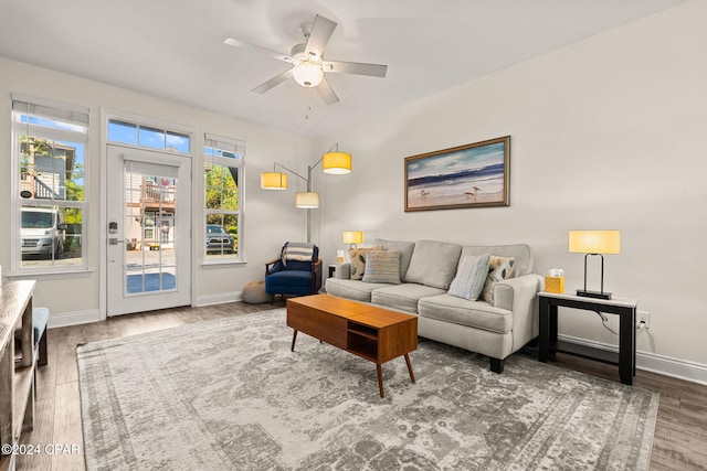 living room with wood-type flooring and ceiling fan