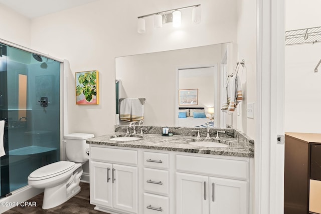 bathroom with vanity, toilet, hardwood / wood-style flooring, and walk in shower