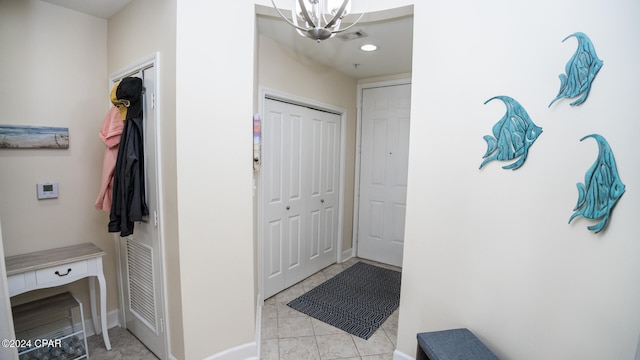 interior space featuring light tile patterned floors and a chandelier