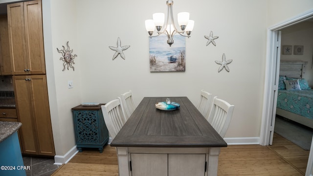 dining space featuring a chandelier and light hardwood / wood-style flooring