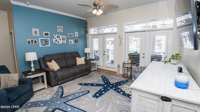 living room with plenty of natural light, ornamental molding, and french doors