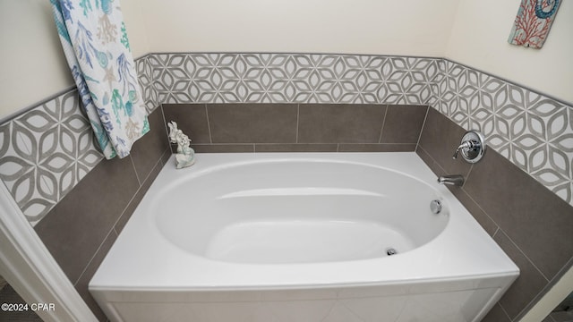 bathroom with a relaxing tiled tub