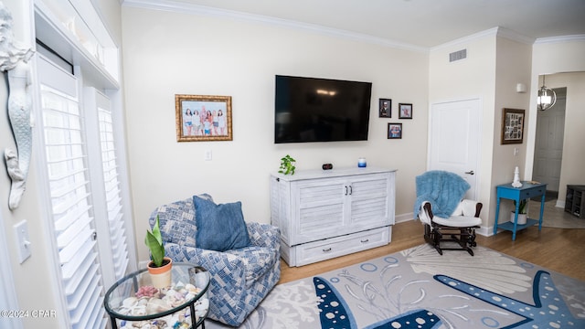 living room with hardwood / wood-style flooring and ornamental molding