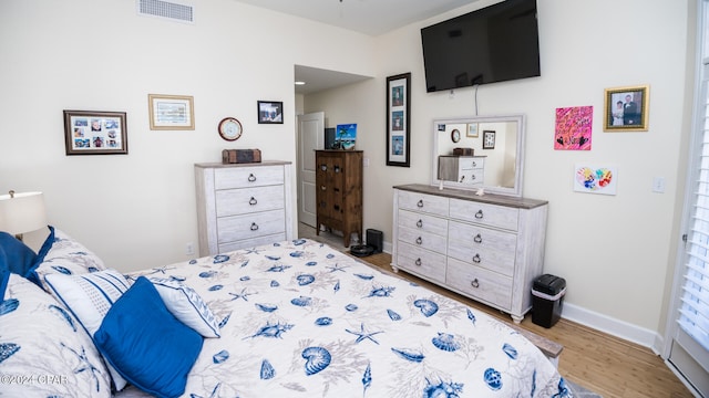 bedroom with light hardwood / wood-style floors