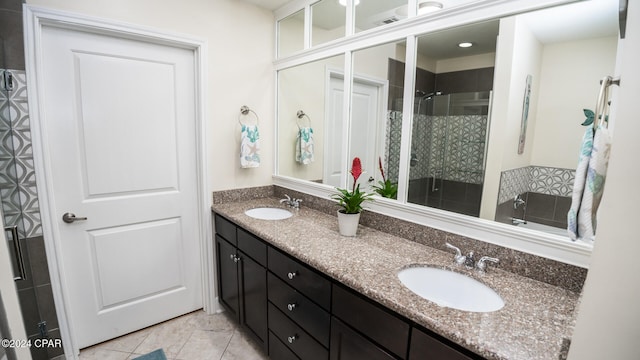 bathroom with tile patterned floors, vanity, and a shower with shower door