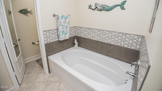 bathroom featuring tile patterned flooring and a tub