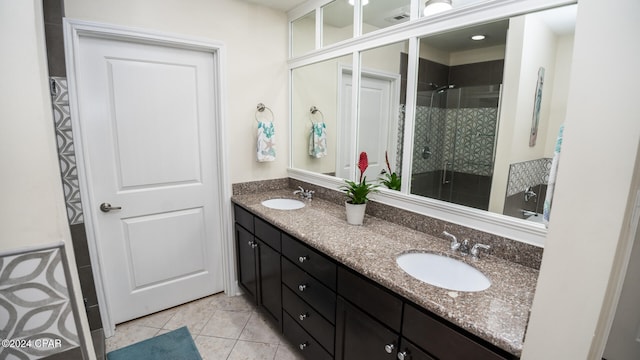 bathroom with tile patterned floors, vanity, and an enclosed shower