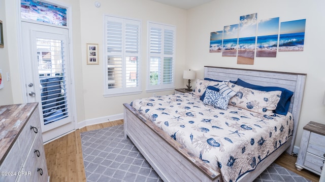 bedroom with dark hardwood / wood-style floors