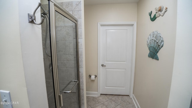 bathroom with tile patterned floors and a shower with door