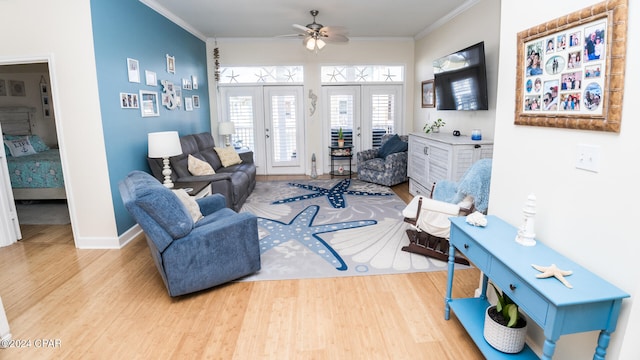 living room with ceiling fan, ornamental molding, light hardwood / wood-style flooring, and french doors