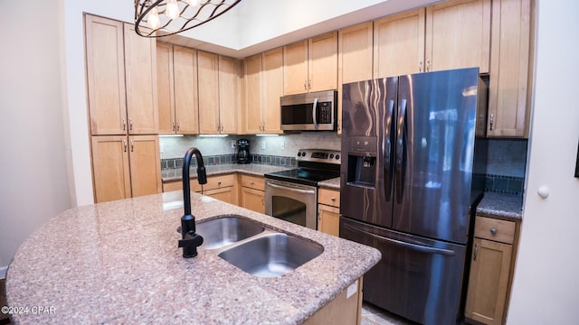 kitchen featuring a sink, appliances with stainless steel finishes, light brown cabinets, and decorative backsplash