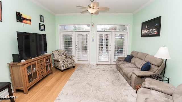 living room with ceiling fan, ornamental molding, and light wood-style floors