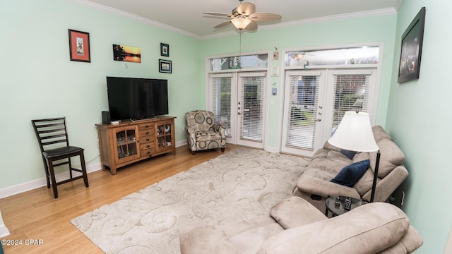 living area with ceiling fan, ornamental molding, wood finished floors, and baseboards