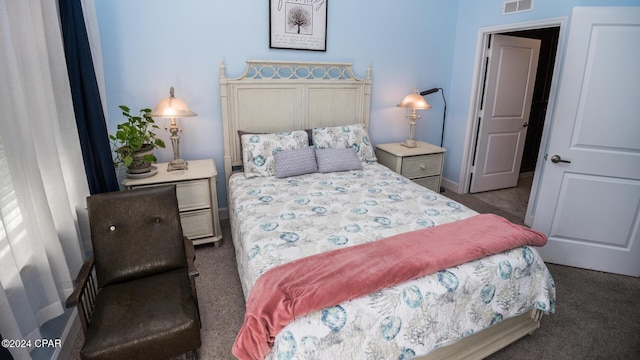 bedroom featuring dark carpet, visible vents, and baseboards