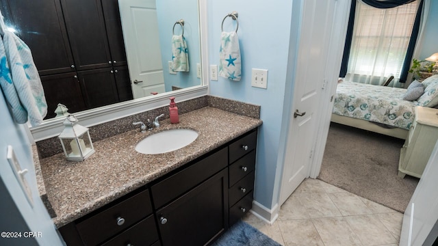 ensuite bathroom featuring tile patterned flooring, vanity, and ensuite bathroom