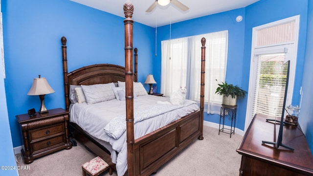 bedroom with light carpet and baseboards