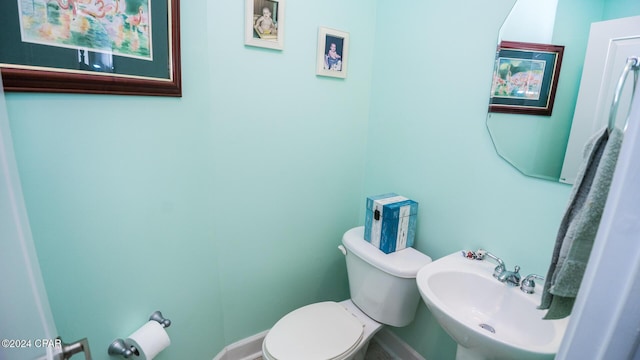 half bath featuring a sink and toilet