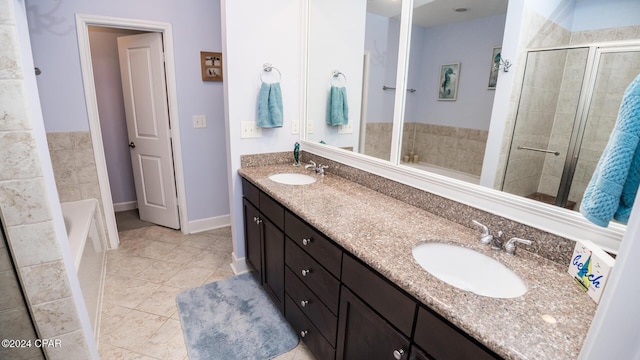 bathroom with a garden tub, double vanity, a sink, and a shower stall