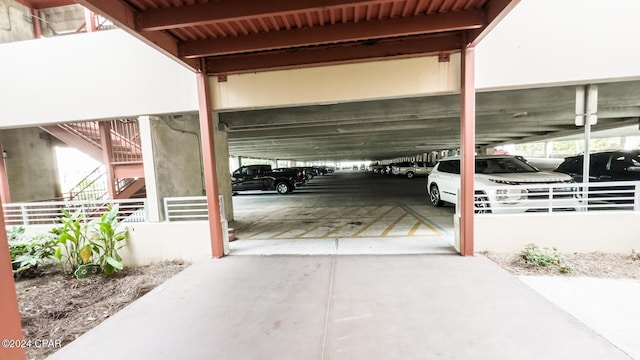 view of parking with a parking garage