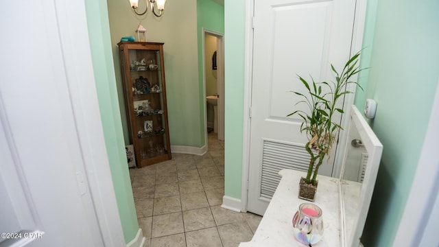 corridor with light tile patterned floors and baseboards