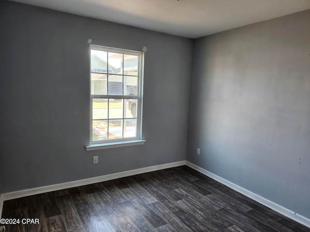 spare room featuring dark hardwood / wood-style flooring