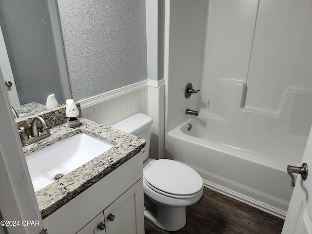 full bathroom featuring bathing tub / shower combination, vanity, wood-type flooring, and toilet