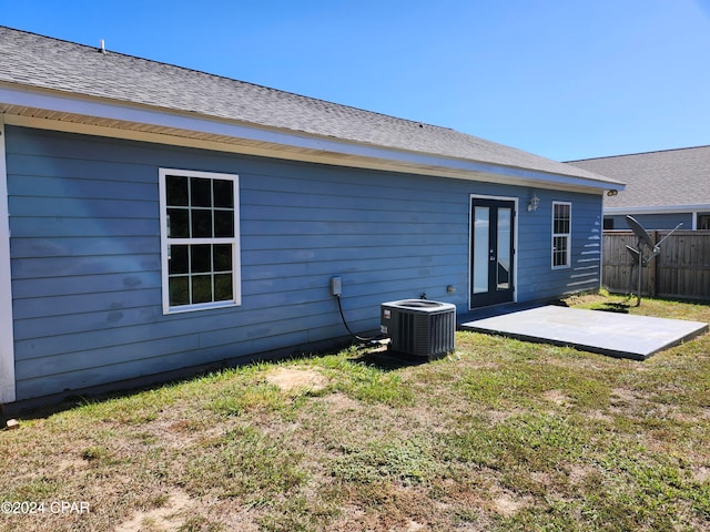 back of property featuring a yard, a patio, and central air condition unit