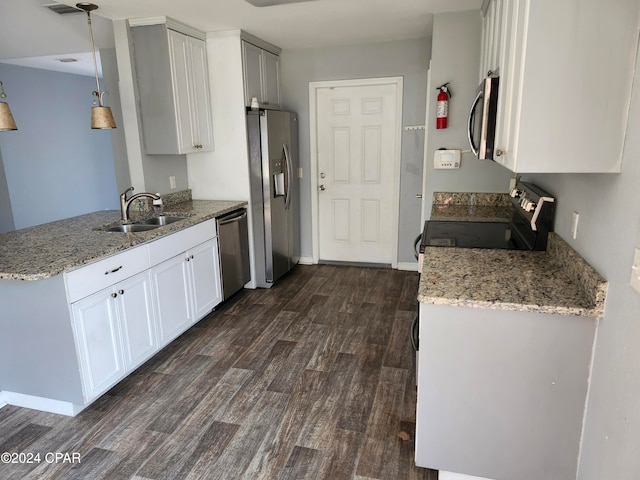 kitchen with white cabinetry, sink, dark wood-type flooring, light stone counters, and appliances with stainless steel finishes