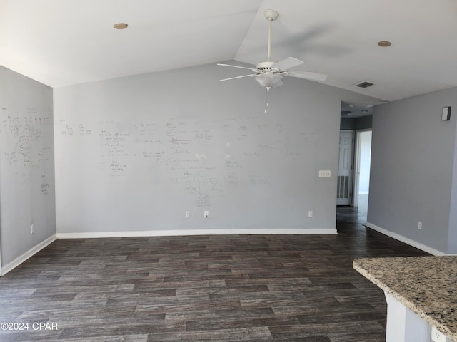 spare room featuring ceiling fan, dark hardwood / wood-style flooring, and lofted ceiling