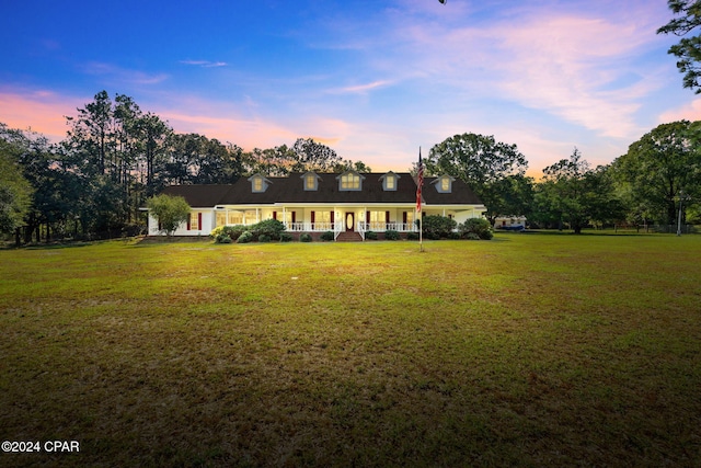 new england style home with a lawn