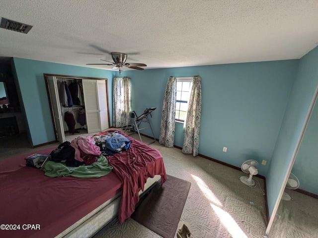 bedroom with a textured ceiling, a closet, and ceiling fan