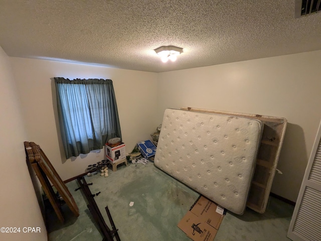 unfurnished bedroom with a textured ceiling