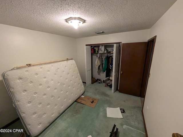 bedroom with a closet and a textured ceiling