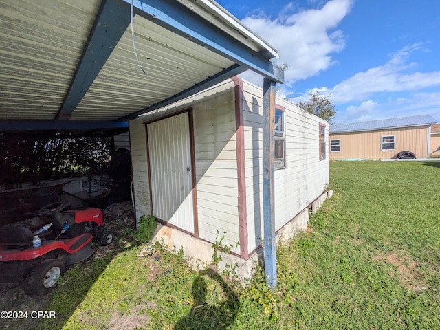 exterior space featuring a yard and a carport