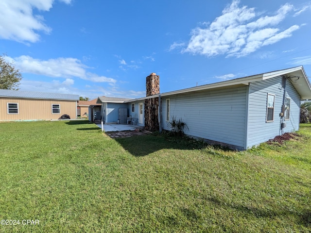 rear view of house with a yard