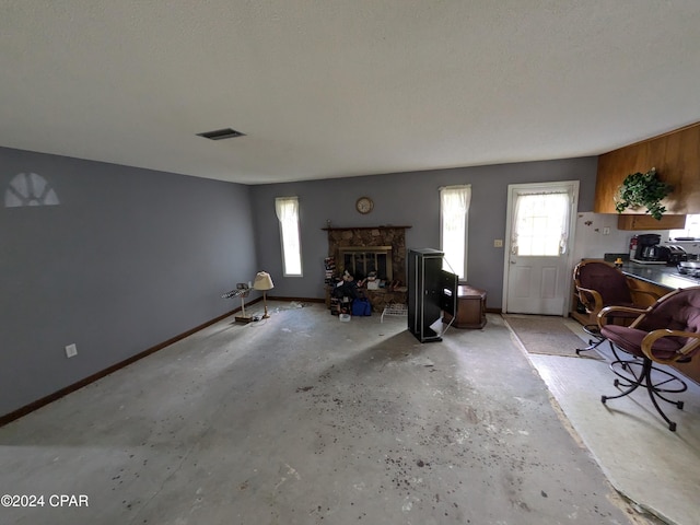 interior space featuring a high end fireplace and a textured ceiling