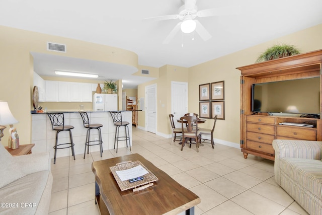 living room with ceiling fan and light tile patterned floors