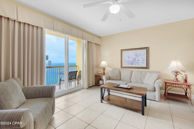 tiled living room featuring a water view and ceiling fan