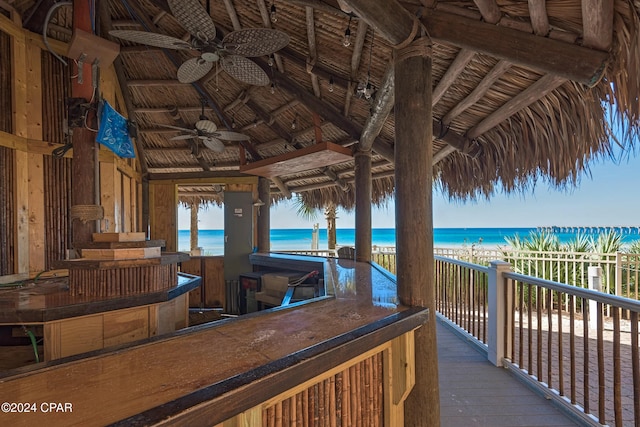 exterior space featuring ceiling fan and a water view