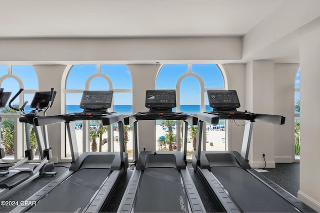 workout area featuring a water view