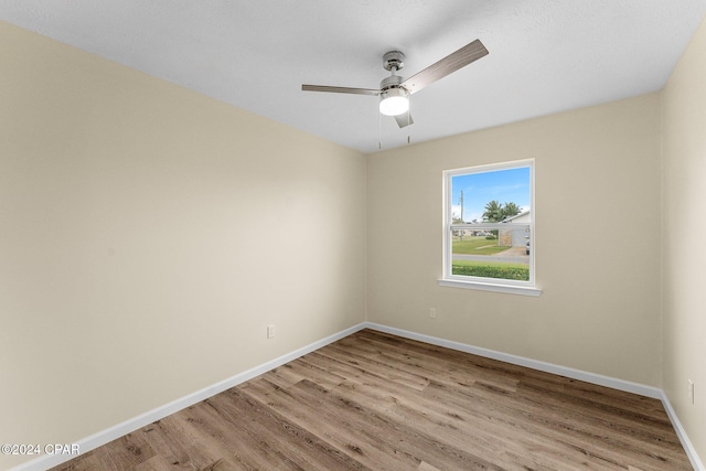 unfurnished room featuring ceiling fan and light hardwood / wood-style flooring