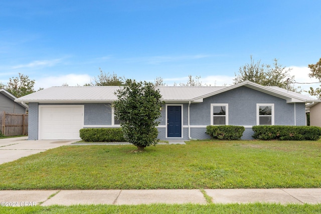 single story home featuring a garage and a front lawn