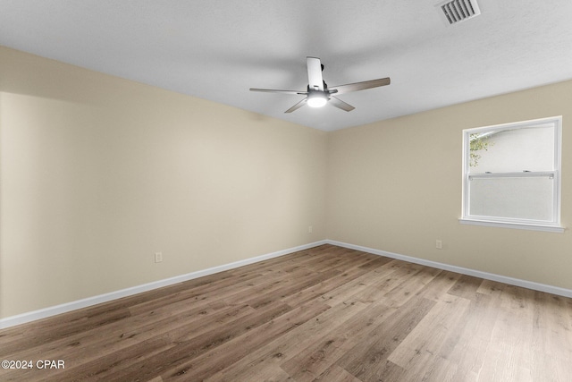 736 E Pine Forest Dr, Lynn Haven, FL 32444 - empty room with wood finished floors, ceiling fan, and baseboards