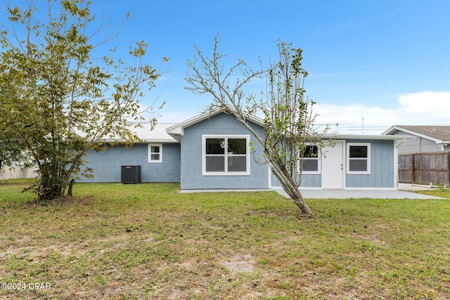 back of property featuring a yard and a patio