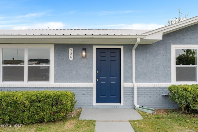 736 E Pine Forest Dr, Lynn Haven, FL 32444 - doorway to property featuring brick siding and stucco siding