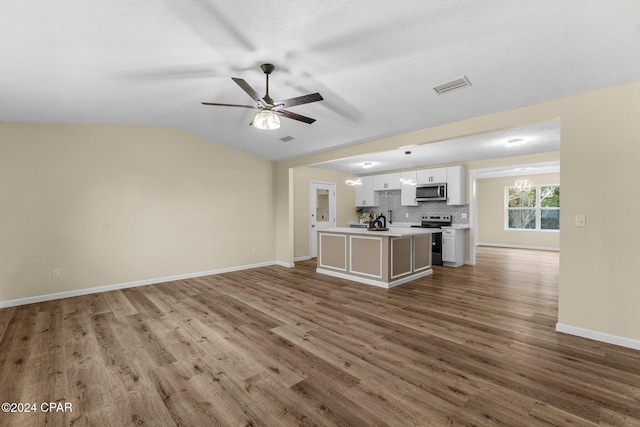 736 E Pine Forest Dr, Lynn Haven, FL 32444 - unfurnished living room featuring wood finished floors, ceiling fan, baseboards, vaulted ceiling, and a sink