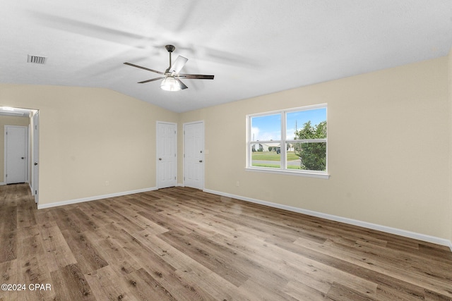736 E Pine Forest Dr, Lynn Haven, FL 32444 - empty room with a ceiling fan, wood finished floors, lofted ceiling, and baseboards