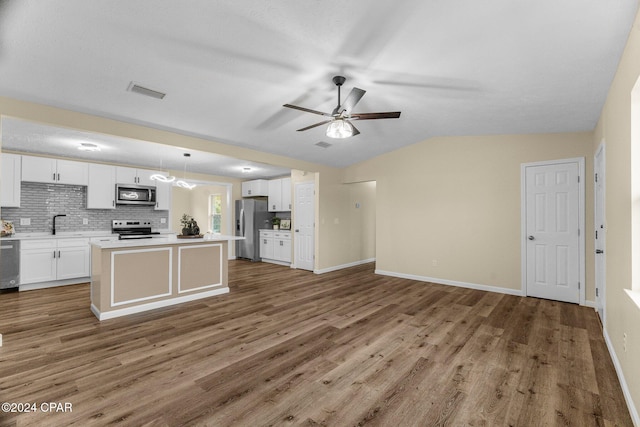 kitchen featuring ceiling fan, hanging light fixtures, appliances with stainless steel finishes, white cabinets, and hardwood / wood-style flooring