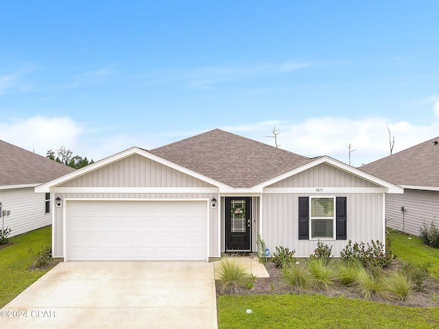 single story home with a front yard and a garage