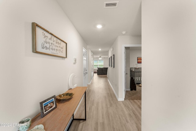 hallway with light hardwood / wood-style flooring